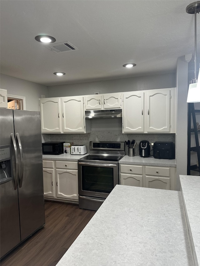 2379 Briarwest Blvd Unit 12, Houston, TX 77077 - kitchen featuring appliances with stainless steel finishes, under cabinet range hood, light countertops, white cabinetry, and recessed lighting
