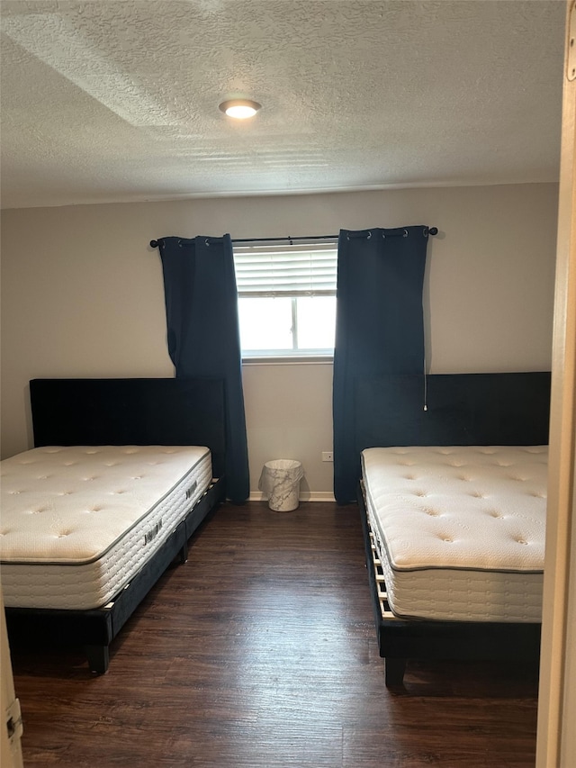 2379 Briarwest Blvd Unit 12, Houston, TX 77077 - bedroom featuring dark wood finished floors and a textured ceiling