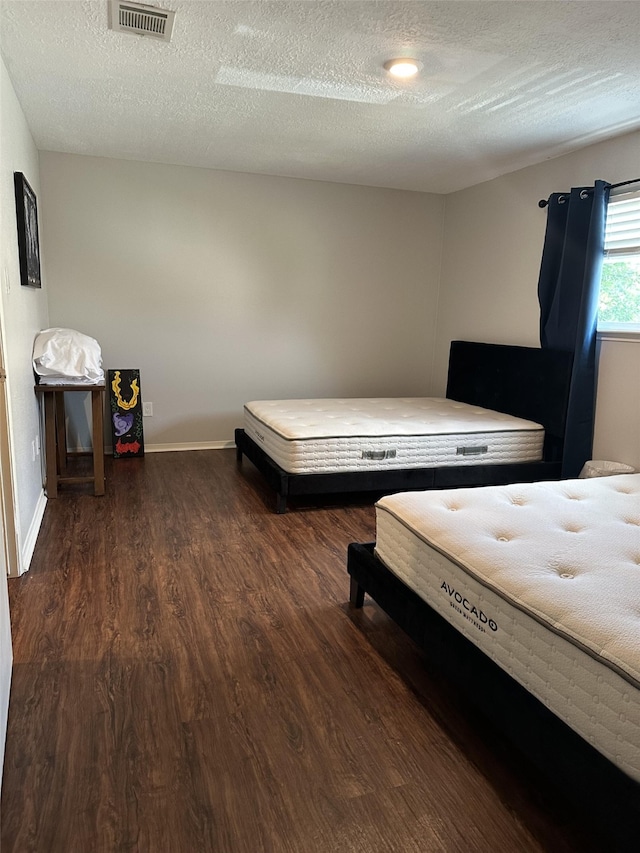2379 Briarwest Blvd Unit 12, Houston, TX 77077 - bedroom featuring wood finished floors and a textured ceiling