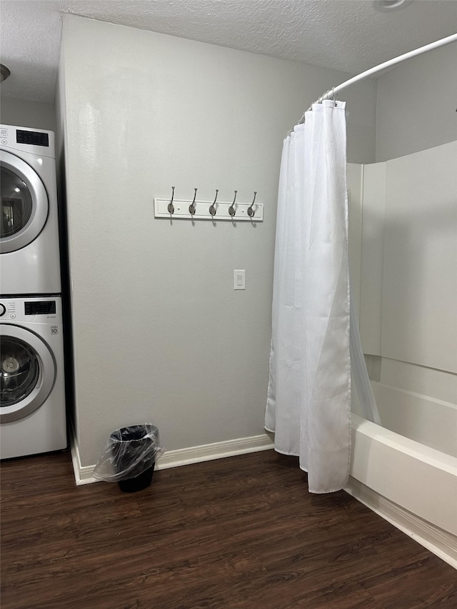 2379 Briarwest Blvd Unit 12, Houston, TX 77077 - laundry room featuring stacked washer and clothes dryer, wood finished floors, and a textured ceiling