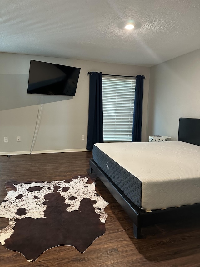 2379 Briarwest Blvd Unit 12, Houston, TX 77077 - bedroom with wood finished floors and a textured ceiling