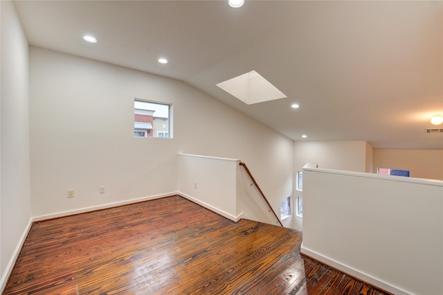2902 Commerce St, Houston, TX 77003 - spare room featuring a skylight, hardwood / wood-style floors, recessed lighting, and vaulted ceiling