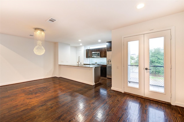2902 Commerce St, Houston, TX 77003 - kitchen with stainless steel microwave, french doors, a peninsula, refrigerator with ice dispenser, and dark wood-style flooring