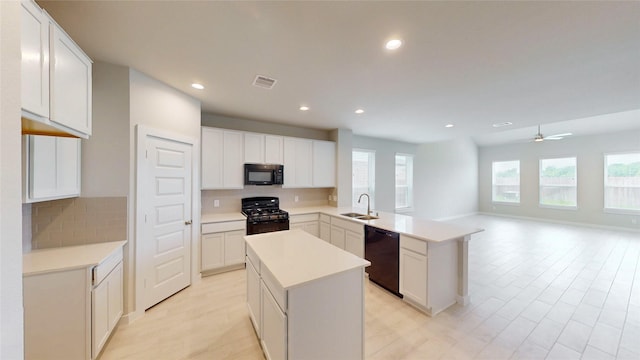 333 Spruce Oak Ln, Waller, TX 77484 - kitchen with black appliances, tasteful backsplash, open floor plan, a peninsula, and recessed lighting