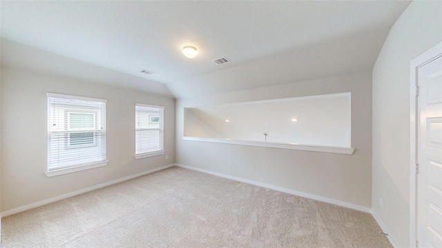 333 Spruce Oak Ln, Waller, TX 77484 - spare room with light colored carpet and vaulted ceiling