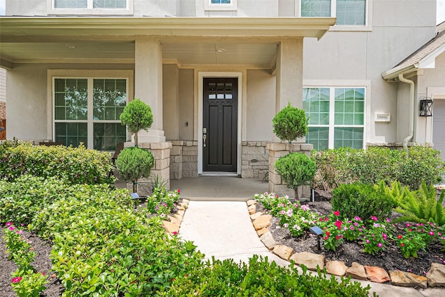 18806 Dove Creek Springs Trl, Cypress, TX 77433 - doorway to property featuring stucco siding, covered porch, and stone siding