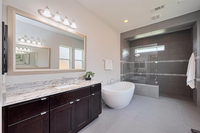 18806 Dove Creek Springs Trl, Cypress, TX 77433 - full bathroom featuring vanity, a freestanding bath, tile patterned floors, a stall shower, and recessed lighting