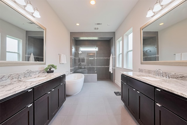 18806 Dove Creek Springs Trl, Cypress, TX 77433 - full bathroom featuring a stall shower, two vanities, tile patterned floors, recessed lighting, and a freestanding bath