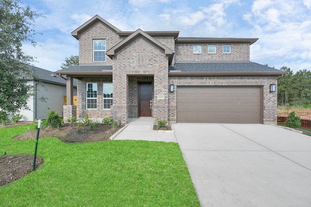 22006 Big Sky Dr, Tomball, TX 77375 - view of front facade with concrete driveway, a front yard, brick siding, and a garage