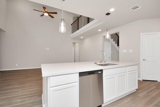 22006 Big Sky Dr, Tomball, TX 77375 - kitchen featuring stainless steel dishwasher, light wood-style floors, white cabinets, pendant lighting, and recessed lighting
