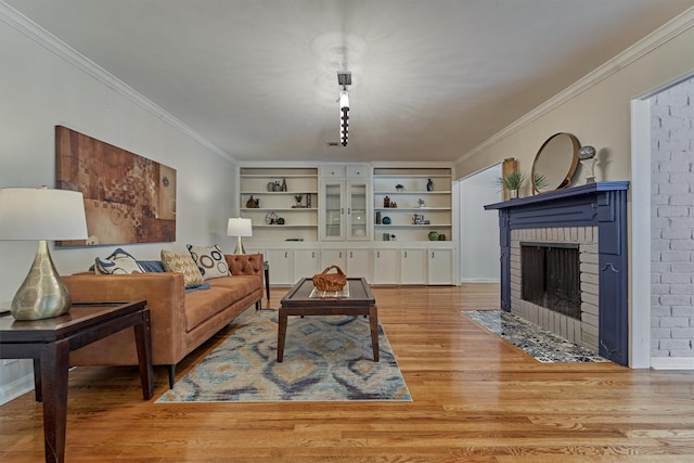 6103 Allentown Dr, Spring, TX 77389 - living room featuring crown molding, a brick fireplace, light wood-type flooring, and built in features