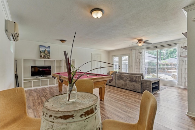 6103 Allentown Dr, Spring, TX 77389 - recreation room with a wall unit AC, billiards table, wood finished floors, ceiling fan, and a textured ceiling