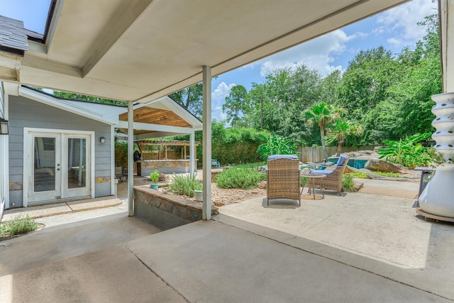 6103 Allentown Dr, Spring, TX 77389 - view of patio / terrace with french doors and view of wooded area