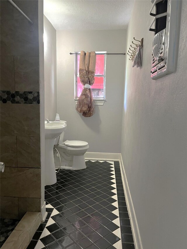 12332 Kayla Ln, Houston, TX 77015 - full bathroom with tiled shower and a textured ceiling