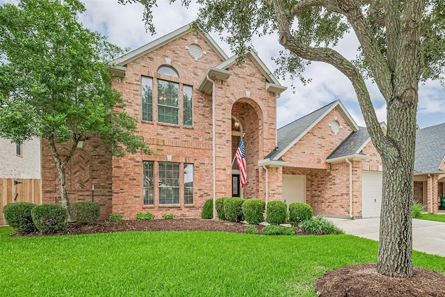 8812 Snowy Owl Loop, Missouri City, TX 77459 - traditional-style home with an attached garage, brick siding, concrete driveway, and a shingled roof