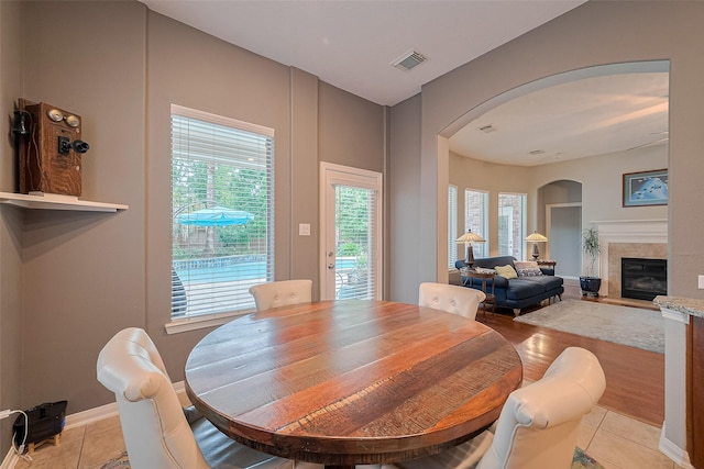 8812 Snowy Owl Loop, Missouri City, TX 77459 - dining area featuring arched walkways, light tile patterned floors, and plenty of natural light