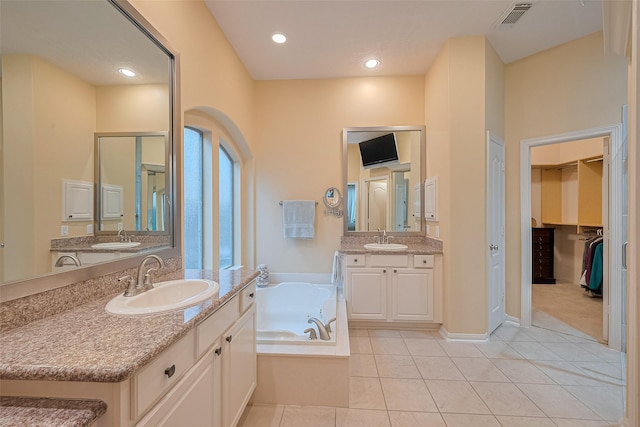8812 Snowy Owl Loop, Missouri City, TX 77459 - bathroom with tile patterned flooring, a garden tub, two vanities, and recessed lighting