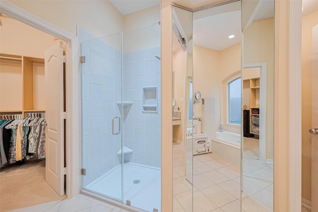8812 Snowy Owl Loop, Missouri City, TX 77459 - full bathroom featuring a stall shower, a garden tub, a spacious closet, and tile patterned floors