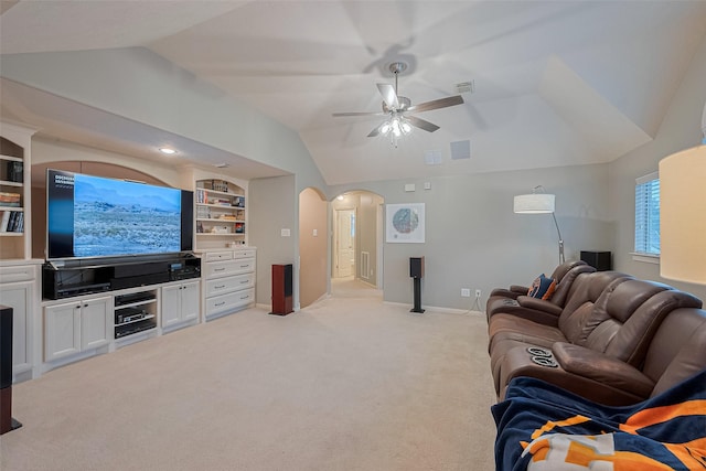 8812 Snowy Owl Loop, Missouri City, TX 77459 - living area featuring lofted ceiling, arched walkways, ceiling fan, light colored carpet, and built in shelves