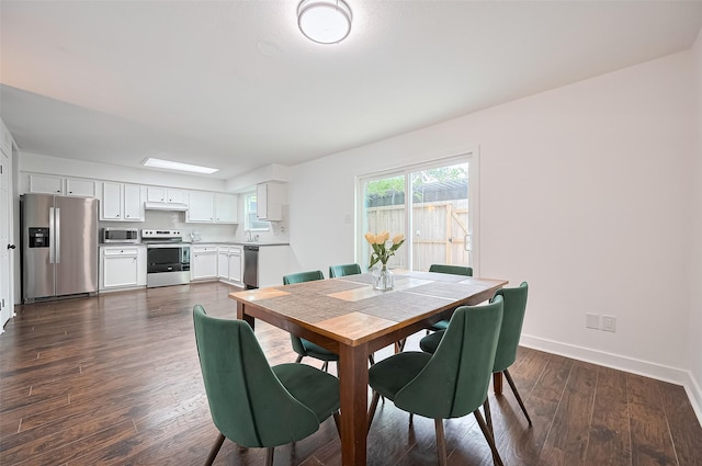 10174 Beekman Place Dr, Houston, TX 77043 - dining space with baseboards and dark wood-type flooring
