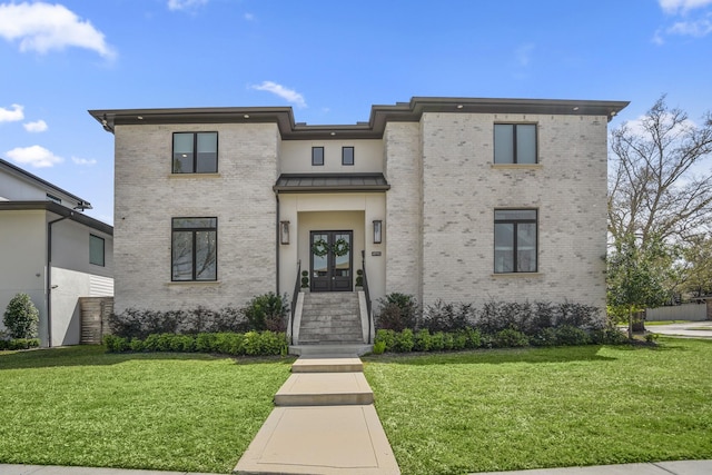 4991 Dumfries Dr, Houston, TX 77096 - view of front of house featuring brick siding, a front lawn, french doors, and a standing seam roof