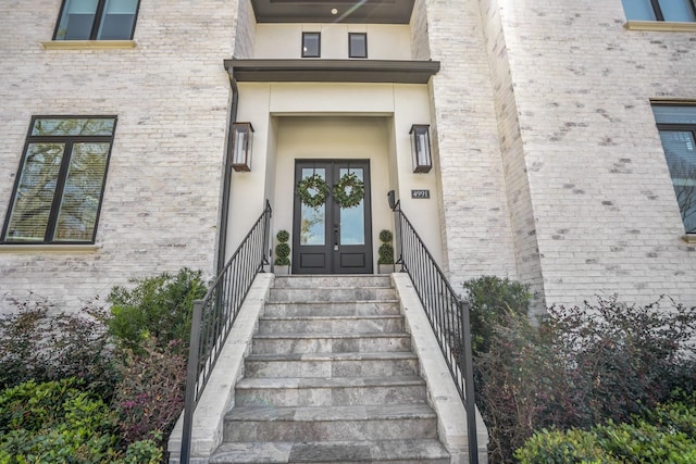 4991 Dumfries Dr, Houston, TX 77096 - view of exterior entry with french doors and stucco siding
