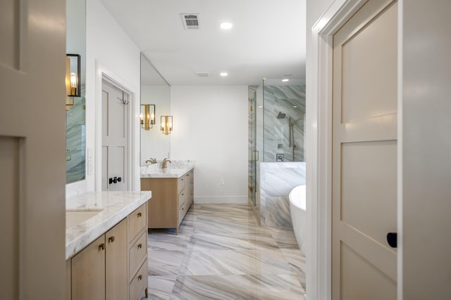 4991 Dumfries Dr, Houston, TX 77096 - bathroom featuring a marble finish shower, marble tiled flooring, two vanities, a freestanding bath, and recessed lighting