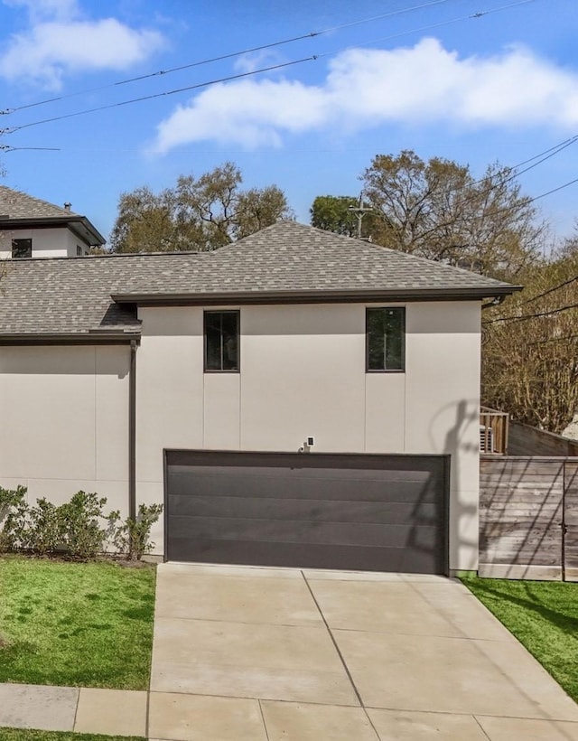 4991 Dumfries Dr, Houston, TX 77096 - view of home's exterior featuring a garage, stucco siding, driveway, and roof with shingles