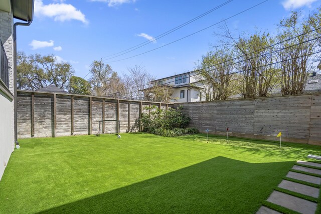 4991 Dumfries Dr, Houston, TX 77096 - fenced backyard featuring a putting area