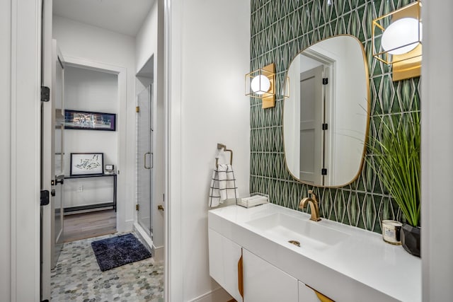 4991 Dumfries Dr, Houston, TX 77096 - full bathroom featuring vanity, a stall shower, tile walls, and tasteful backsplash