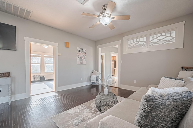 206 S Idaho St, La Porte, TX 77571 - living area with a ceiling fan and dark wood-style flooring