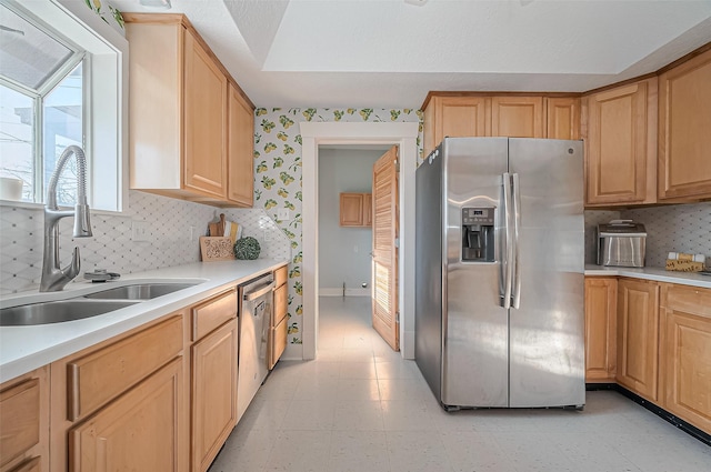 206 S Idaho St, La Porte, TX 77571 - kitchen with stainless steel appliances, light countertops, light floors, tasteful backsplash, and wallpapered walls