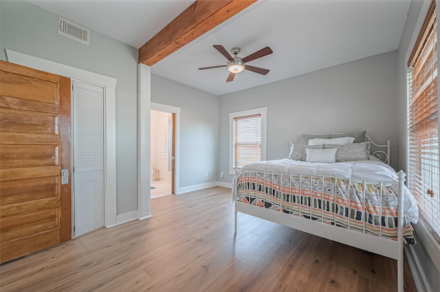 206 S Idaho St, La Porte, TX 77571 - bedroom with beamed ceiling, light wood-style flooring, a ceiling fan, and ensuite bath