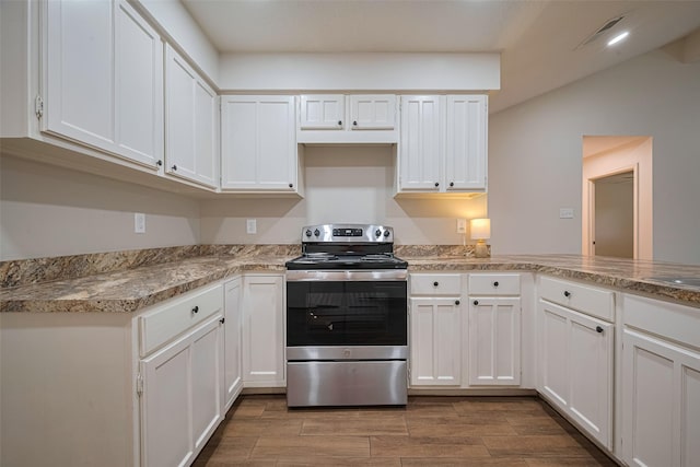 19718 Franz Rd, Houston, TX 77084 - kitchen featuring stainless steel electric range oven, white cabinetry, wood finished floors, and light countertops