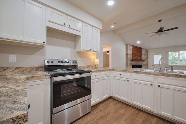 19718 Franz Rd, Houston, TX 77084 - kitchen with electric stove, light wood-style flooring, ceiling fan, white cabinets, and recessed lighting