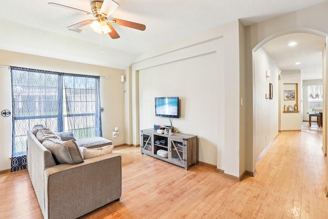 3211 Waterglen Ct, League City, TX 77573 - living area with arched walkways, light wood-style floors, and ceiling fan