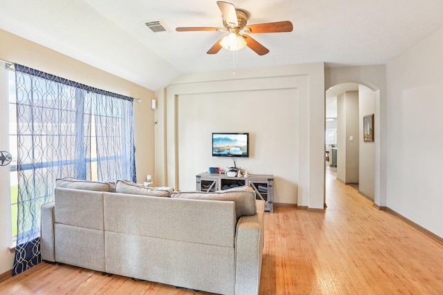 3211 Waterglen Ct, League City, TX 77573 - living room featuring arched walkways, a ceiling fan, and light wood finished floors