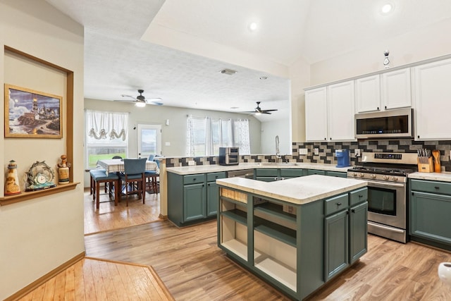 3211 Waterglen Ct, League City, TX 77573 - kitchen with green cabinets, appliances with stainless steel finishes, a peninsula, and recessed lighting