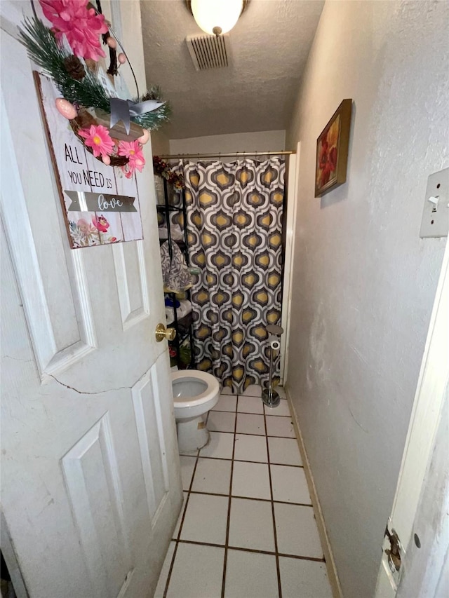 1107 Wooding St, Houston, TX 77011 - bathroom featuring a textured ceiling, tile patterned flooring, and a shower with shower curtain