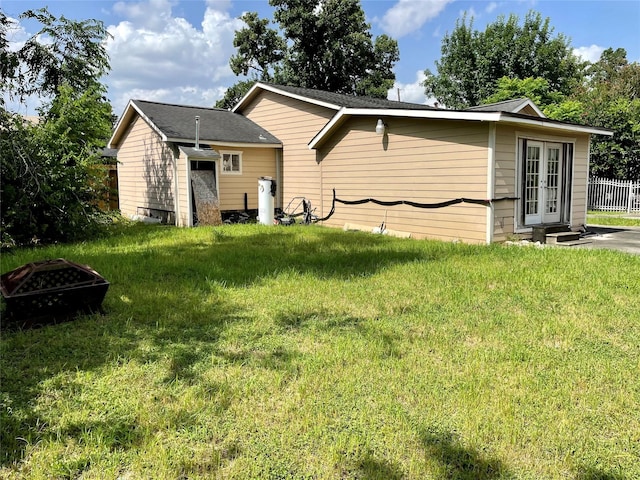 1107 Wooding St, Houston, TX 77011 - rear view of property with french doors and a fire pit