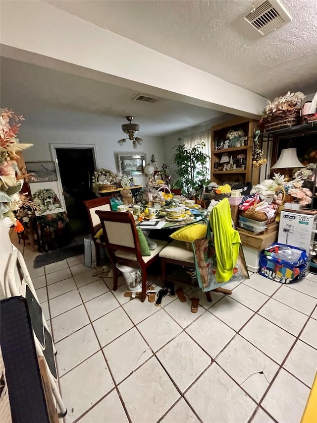 1107 Wooding St, Houston, TX 77011 - dining area with light tile patterned flooring and a textured ceiling
