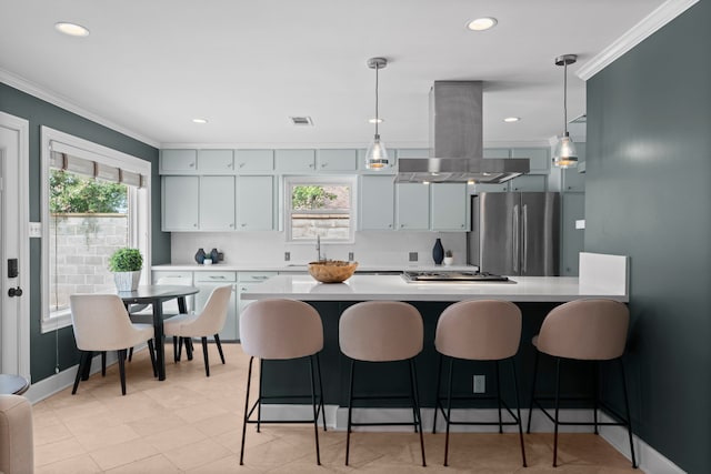 2119 Latexo Dr, Houston, TX 77018 - kitchen with appliances with stainless steel finishes, island range hood, ornamental molding, a kitchen breakfast bar, and light countertops