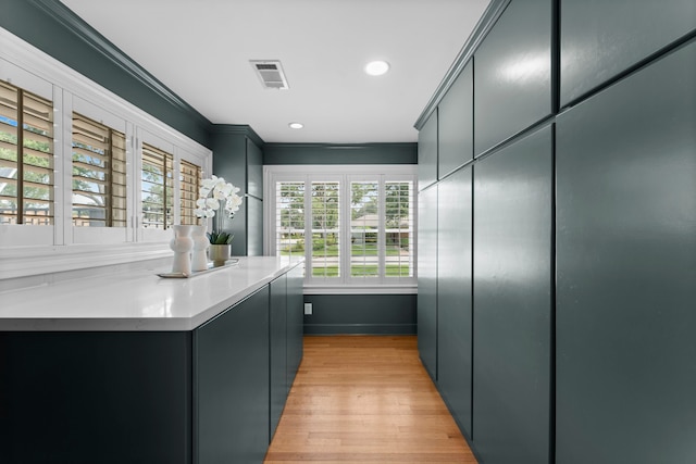 2119 Latexo Dr, Houston, TX 77018 - kitchen with ornamental molding, light wood-style flooring, recessed lighting, and light countertops