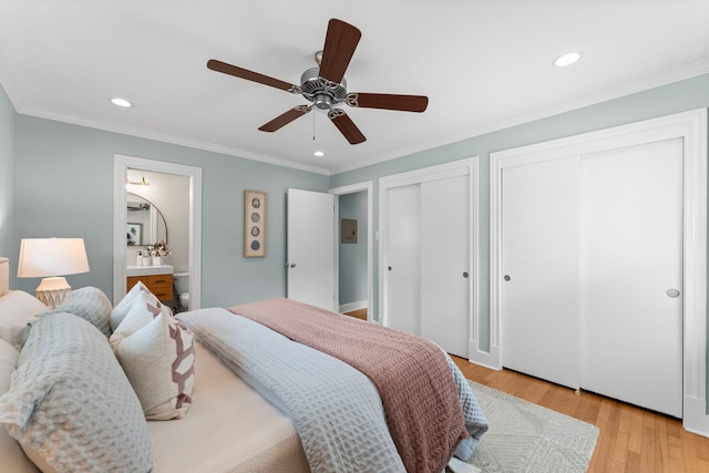 2119 Latexo Dr, Houston, TX 77018 - bedroom featuring multiple closets, light wood-type flooring, recessed lighting, crown molding, and ensuite bath