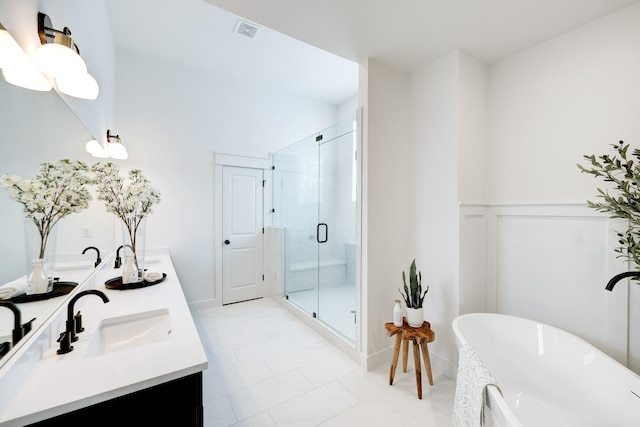 9311 Montridge Dr, Houston, TX 77080 - full bath with double vanity, a freestanding tub, a shower stall, and a wainscoted wall