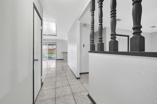 619 Rocky Mountain Dr, Houston, TX 77037 - hallway featuring a textured wall and light tile patterned flooring