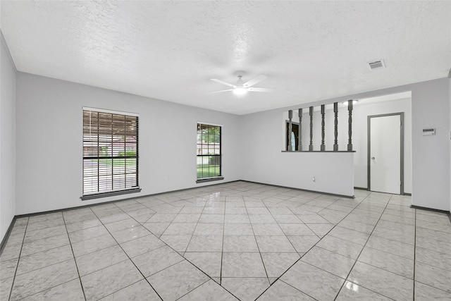619 Rocky Mountain Dr, Houston, TX 77037 - unfurnished room featuring a textured ceiling, ceiling fan, and light tile patterned flooring