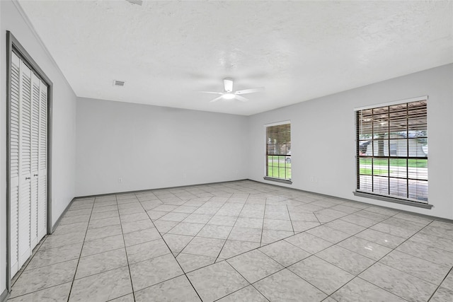 619 Rocky Mountain Dr, Houston, TX 77037 - unfurnished room featuring a ceiling fan, a textured ceiling, and light tile patterned floors