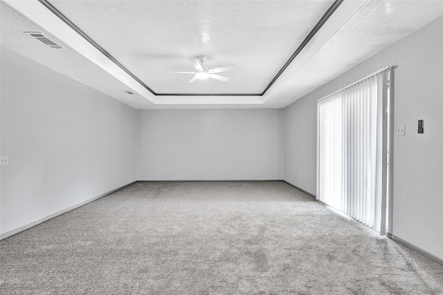 619 Rocky Mountain Dr, Houston, TX 77037 - spare room with a ceiling fan, a raised ceiling, carpet, and a textured ceiling