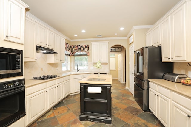 14310 Saint Pierre Ln, Cypress, TX 77429 - kitchen featuring black appliances, light countertops, tasteful backsplash, under cabinet range hood, and crown molding